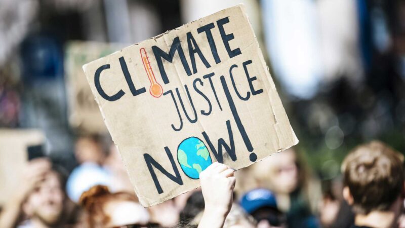 Climate Justice now banner at march
